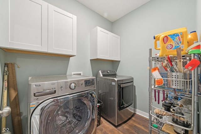 washroom with washing machine and clothes dryer, cabinet space, dark wood-style floors, and baseboards