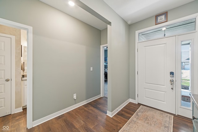 entryway with baseboards and dark wood-style flooring