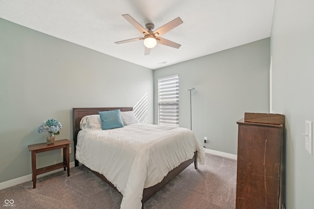 bedroom with baseboards, carpet floors, visible vents, and a ceiling fan