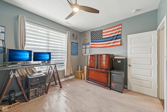 office area with a ceiling fan, carpet floors, baseboards, and visible vents