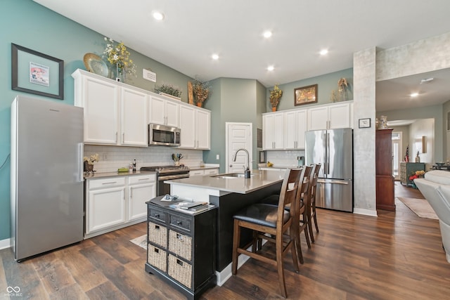 kitchen with white cabinetry, light countertops, a sink, and stainless steel appliances