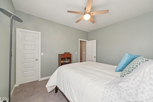 carpeted bedroom with baseboards and ceiling fan