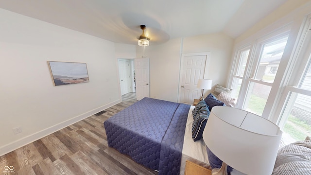 926 N Dearborn St, Indianapolis, IN 46201 - bedroom with wood finished floors, baseboards, and ceiling fan