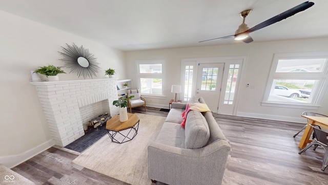 926 N Dearborn St, Indianapolis, IN 46201 - living room featuring a fireplace, baseboards, a healthy amount of sunlight, and wood finished floors
