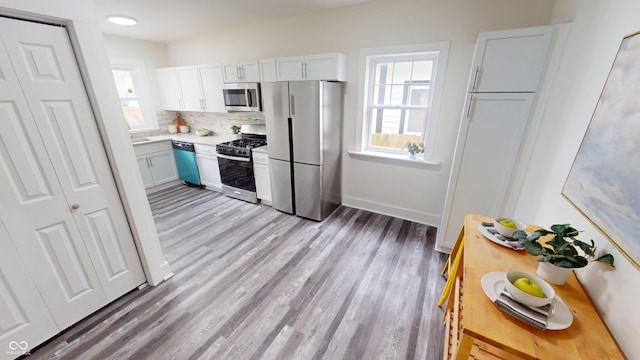 926 N Dearborn St, Indianapolis, IN 46201 - kitchen with light countertops, appliances with stainless steel finishes, plenty of natural light, and light wood-style floors