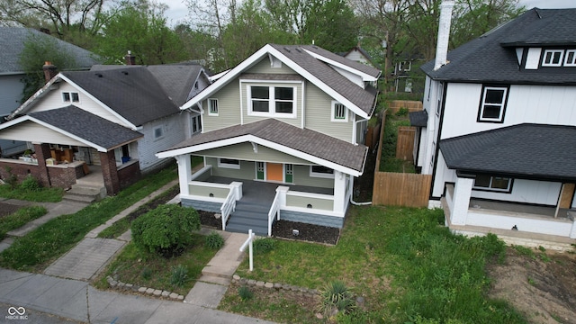 926 N Dearborn St, Indianapolis, IN 46201 - view of front of house featuring stairs, covered porch, and fence