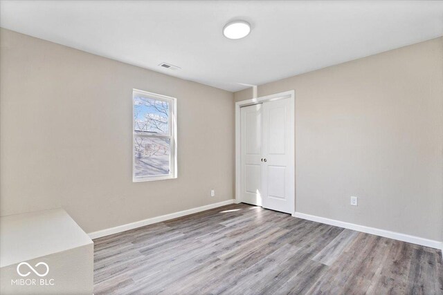 243 N Tacoma Ave, Indianapolis, IN 46201 - empty room featuring wood finished floors and baseboards