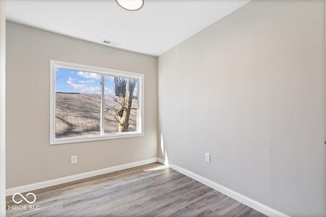 243 N Tacoma Ave, Indianapolis, IN 46201 - spare room with wood finished floors and baseboards