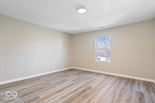 243 N Tacoma Ave, Indianapolis, IN 46201 - spare room featuring wood finished floors and baseboards