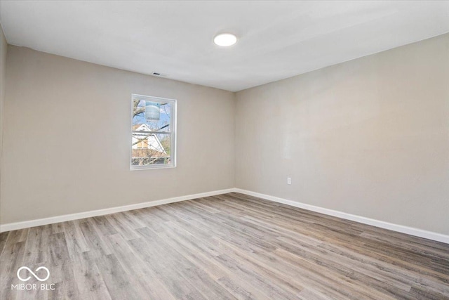 243 N Tacoma Ave, Indianapolis, IN 46201 - empty room featuring wood finished floors and baseboards