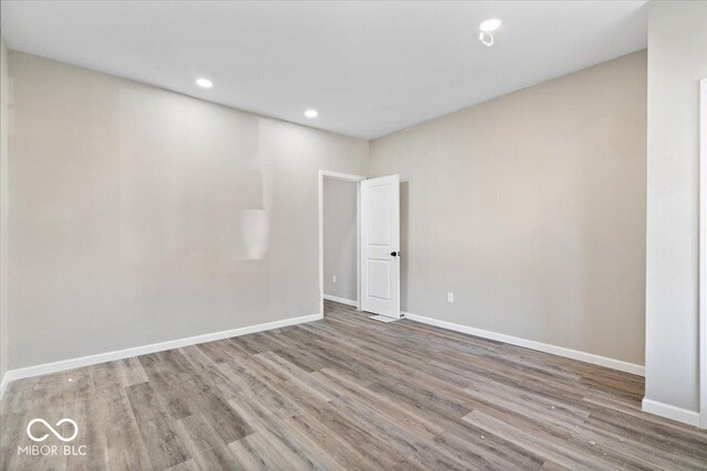 243 N Tacoma Ave, Indianapolis, IN 46201 - spare room with wood finished floors, baseboards, and recessed lighting