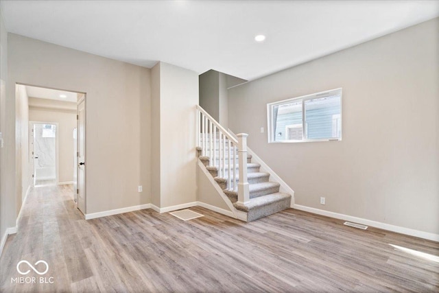 243 N Tacoma Ave, Indianapolis, IN 46201 - empty room with stairs, wood finished floors, baseboards, and recessed lighting