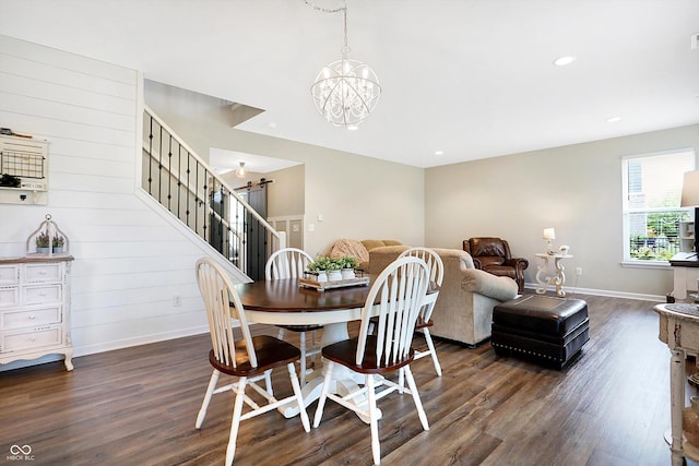 dining area featuring a notable chandelier, baseboards, stairs, and dark wood finished floors