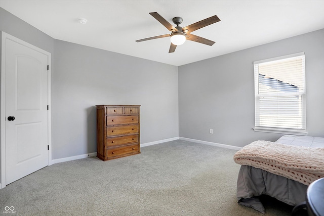 carpeted bedroom with baseboards and a ceiling fan