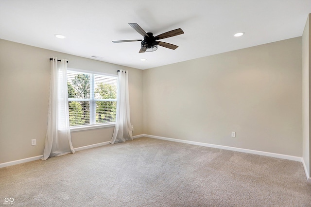 empty room featuring light colored carpet, recessed lighting, baseboards, and a ceiling fan