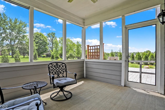 sunroom featuring a ceiling fan and plenty of natural light