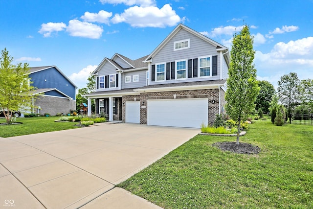 traditional-style house featuring driveway, brick siding, a garage, and a front lawn