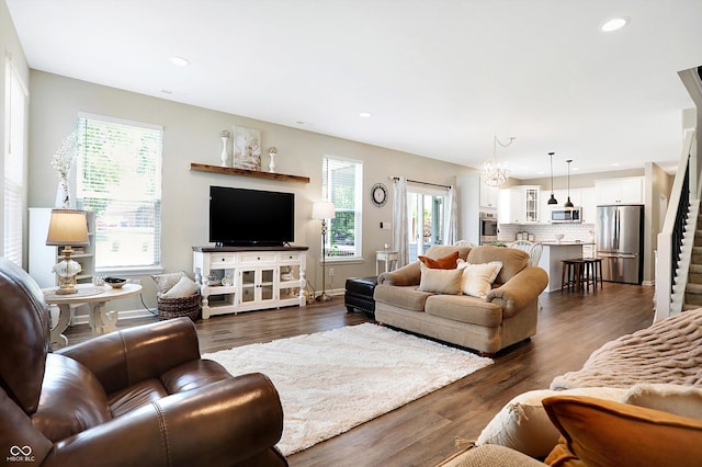 living area featuring recessed lighting, baseboards, stairway, and dark wood finished floors