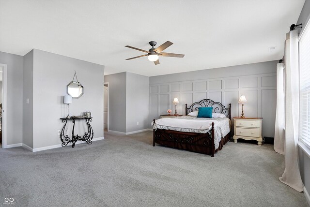 bedroom with baseboards, a ceiling fan, and carpet