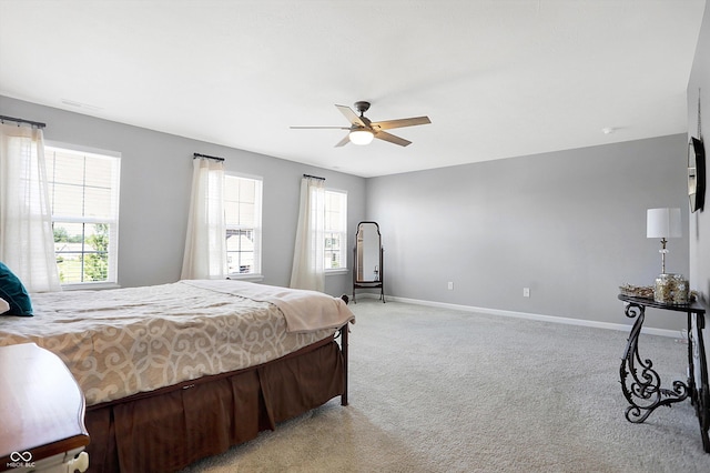 bedroom featuring a ceiling fan, light carpet, baseboards, and visible vents
