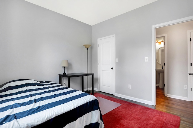 bedroom with baseboards and wood finished floors