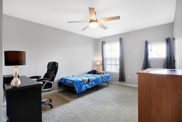 carpeted bedroom featuring baseboards, visible vents, and a ceiling fan