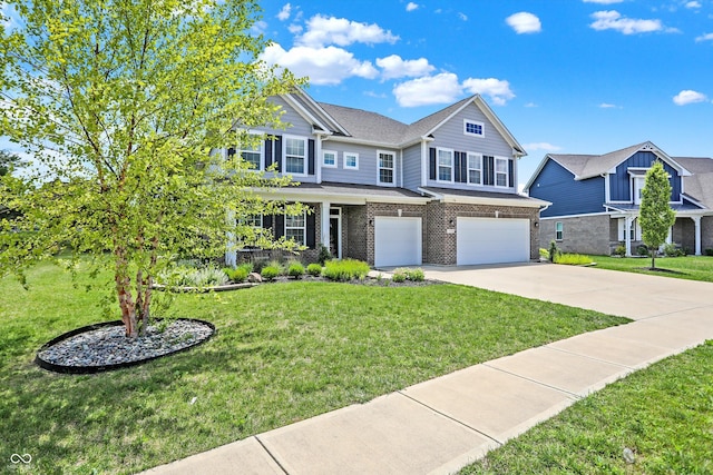 view of front of house with driveway, a front yard, an attached garage, and brick siding