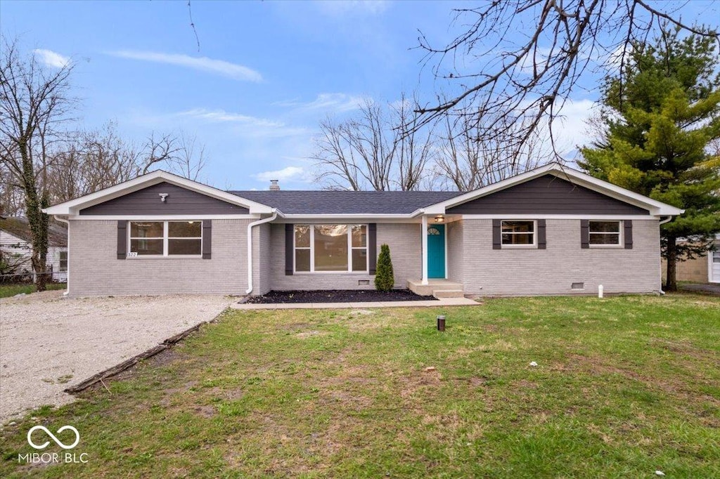 ranch-style house with a front yard, brick siding, driveway, and a chimney