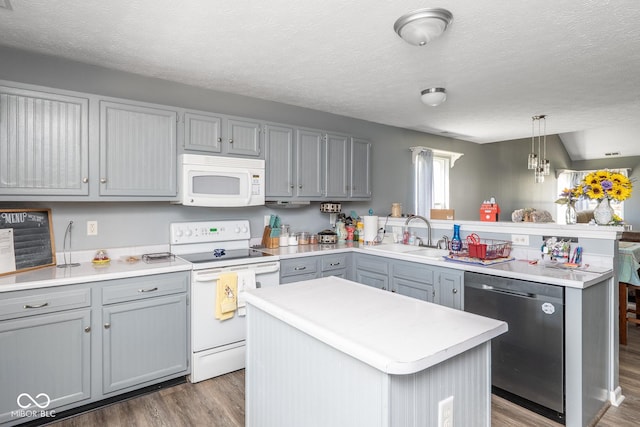 329 Dogwood Dr, Pendleton, IN 46064 - kitchen featuring white appliances, a sink, gray cabinetry, wood finished floors, and a textured ceiling