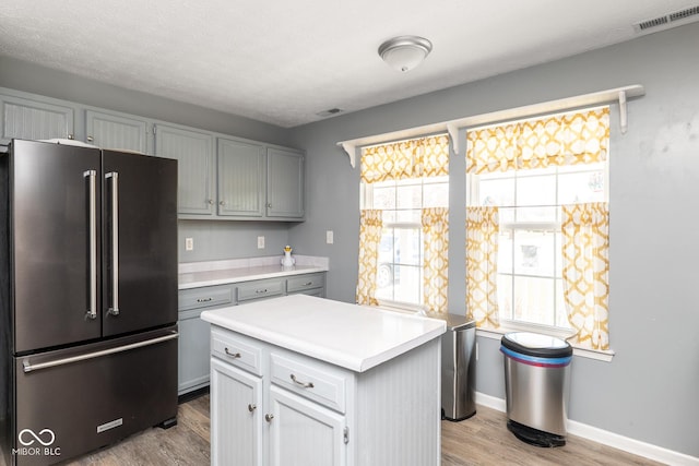 329 Dogwood Dr, Pendleton, IN 46064 - kitchen featuring high quality fridge, light countertops, light wood-style flooring, gray cabinets, and baseboards