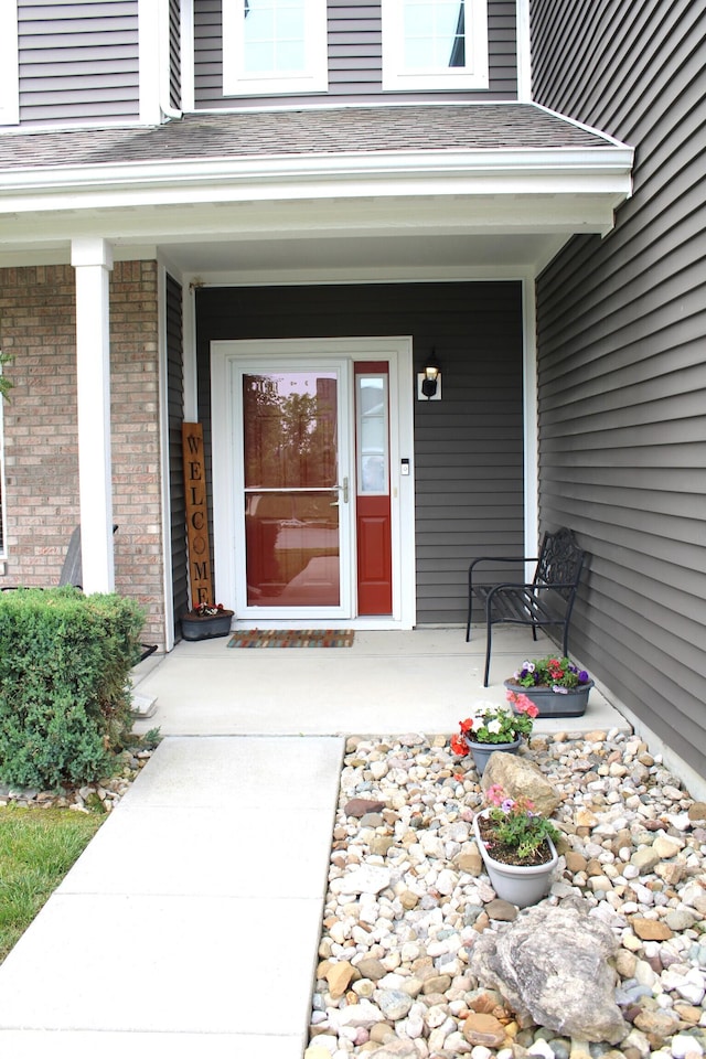 981 Redwood Dr, Franklin, IN 46131 - entrance to property featuring a porch, brick siding, and a shingled roof