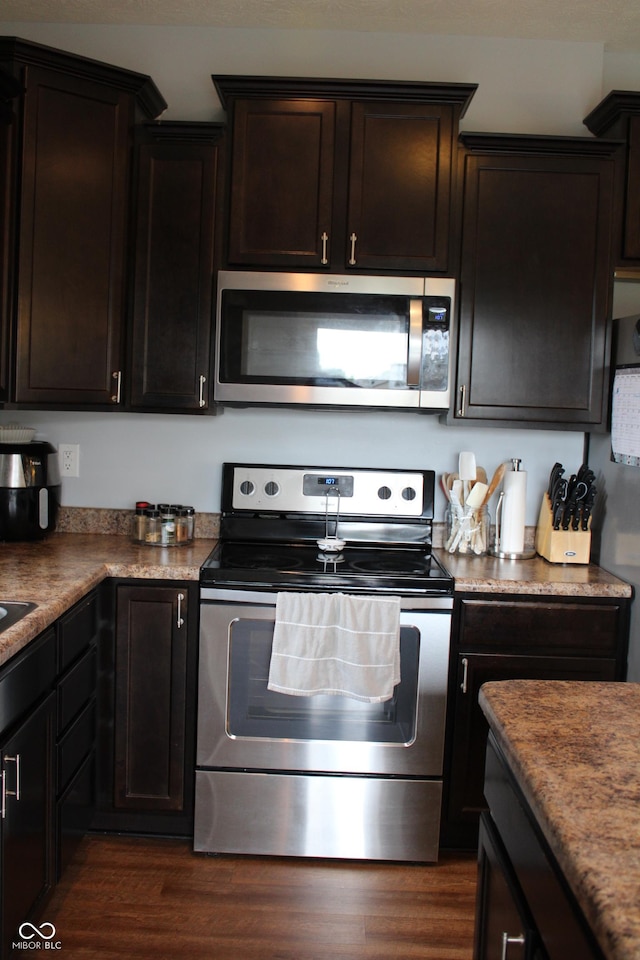 981 Redwood Dr, Franklin, IN 46131 - kitchen featuring stainless steel appliances, dark brown cabinets, and dark wood-style floors