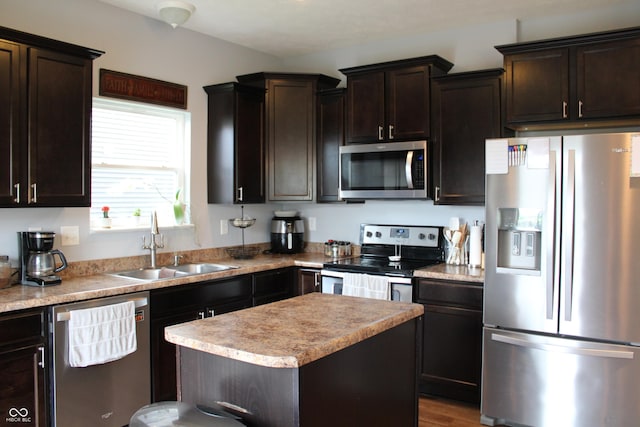981 Redwood Dr, Franklin, IN 46131 - kitchen featuring appliances with stainless steel finishes, dark brown cabinets, light countertops, a center island, and wood finished floors