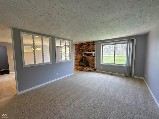 unfurnished living room with baseboards, a textured ceiling, visible vents, and carpet