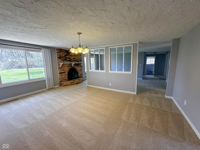 unfurnished living room featuring carpet flooring, a textured ceiling, visible vents, and a notable chandelier