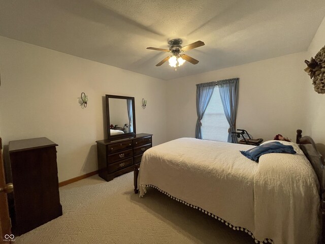 1310 Pin Oak Dr, Seymour, IN 47274 - bedroom with baseboards, a textured ceiling, ceiling fan, and light carpet