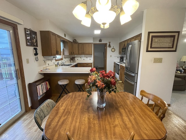 1310 Pin Oak Dr, Seymour, IN 47274 - dining area featuring an inviting chandelier and light wood-type flooring