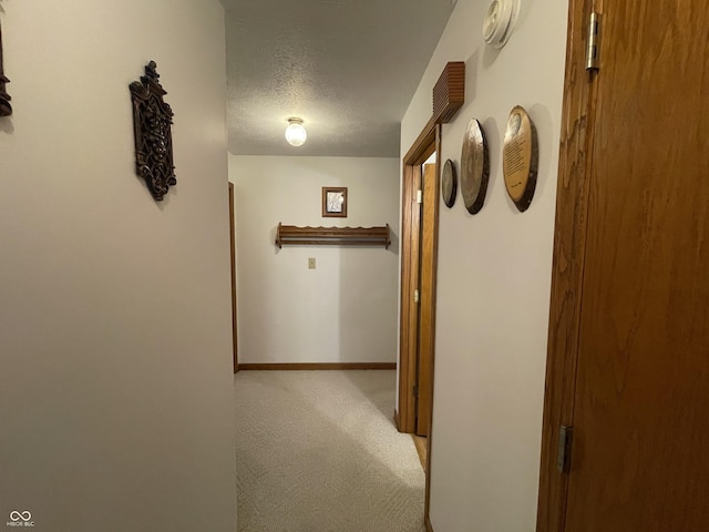 1310 Pin Oak Dr, Seymour, IN 47274 - hall featuring light carpet, baseboards, and a textured ceiling