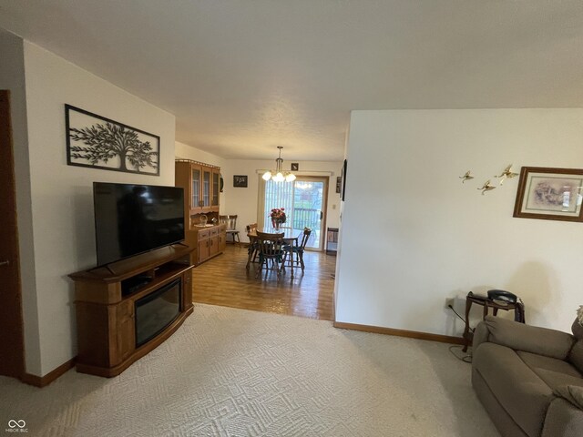 1310 Pin Oak Dr, Seymour, IN 47274 - living room with baseboards, an inviting chandelier, and light carpet