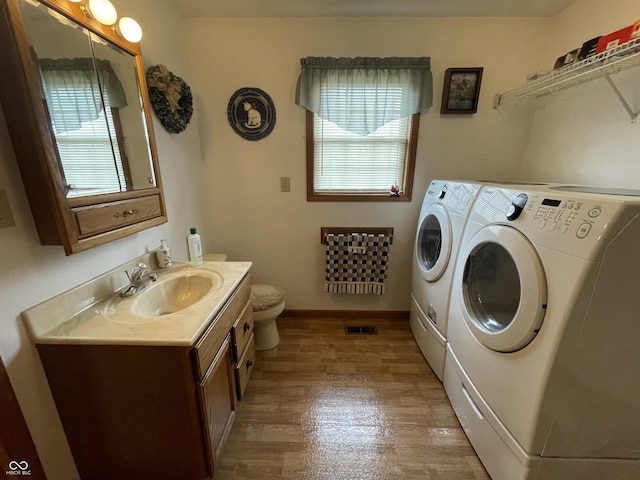 1310 Pin Oak Dr, Seymour, IN 47274 - laundry room with a sink, washing machine and clothes dryer, light wood-style flooring, laundry area, and baseboards