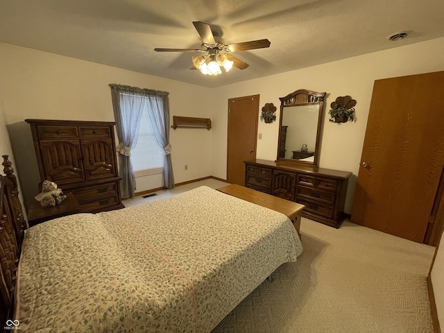 1310 Pin Oak Dr, Seymour, IN 47274 - bedroom featuring light colored carpet, visible vents, baseboards, and a ceiling fan