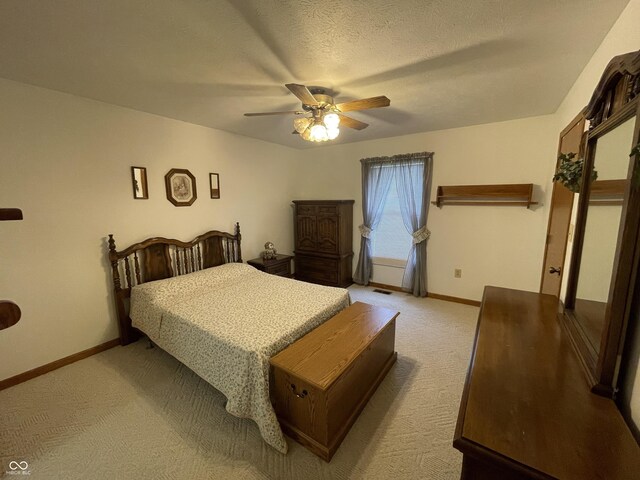 1310 Pin Oak Dr, Seymour, IN 47274 - bedroom with a textured ceiling, baseboards, light colored carpet, and ceiling fan