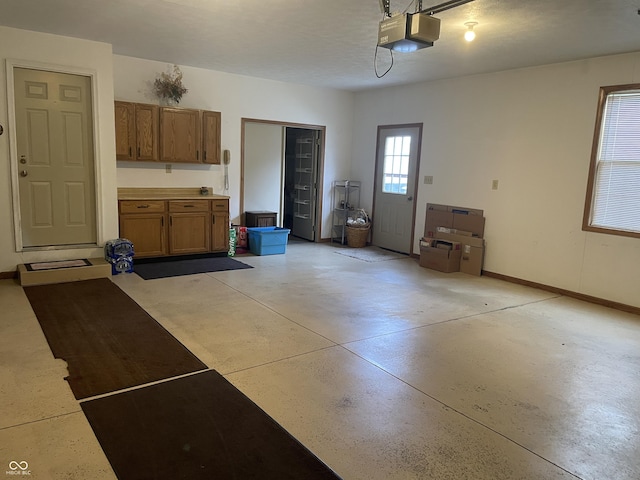 1310 Pin Oak Dr, Seymour, IN 47274 - garage featuring a garage door opener and baseboards