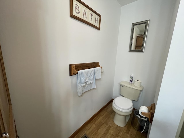 1310 Pin Oak Dr, Seymour, IN 47274 - bathroom featuring baseboards, wood finished floors, and toilet
