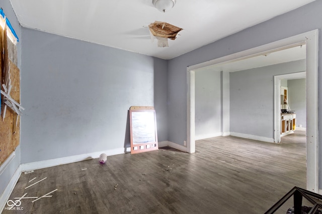 unfurnished room featuring wood finished floors and baseboards