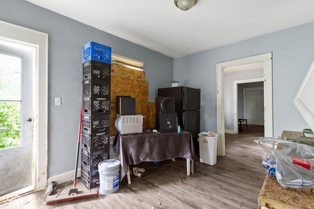misc room with baseboards and wood finished floors