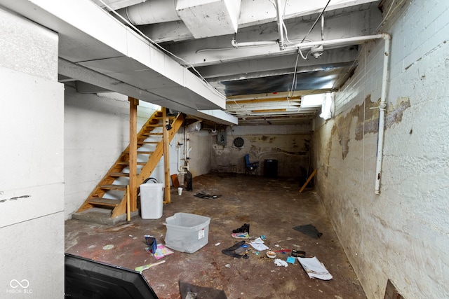 unfinished basement featuring stairs