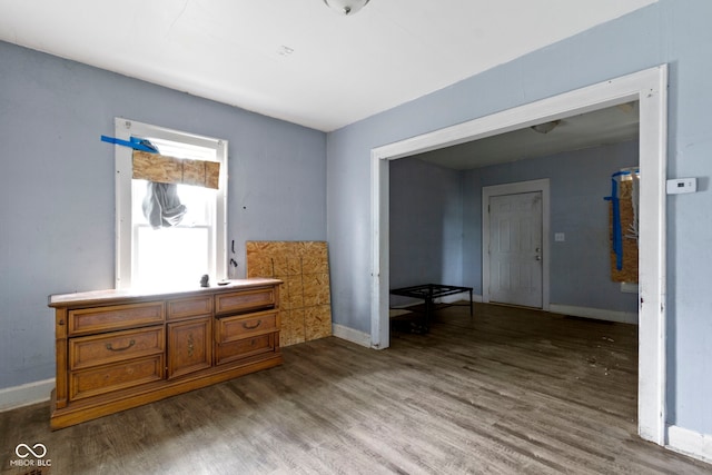 sitting room featuring baseboards and wood finished floors