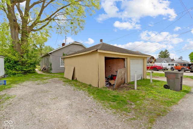 view of home's exterior featuring an outdoor structure and a detached garage