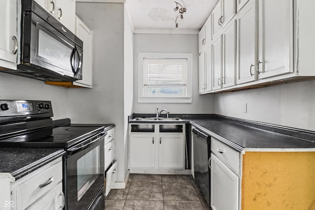 kitchen with a sink, black appliances, white cabinetry, and dark countertops